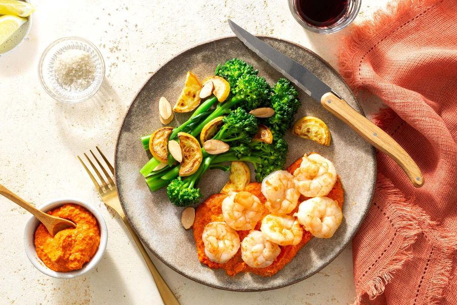 Steaks and romesco with baby broccoli, summer squash, and almonds