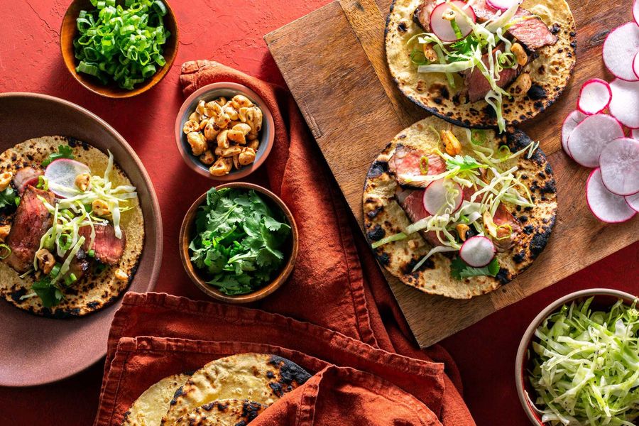 Spicy Korean steak tacos with honey-lime slaw and toasted cashews