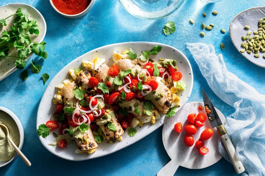 Papadzules with eggs and pumpkin seed and spicy tomato sauces