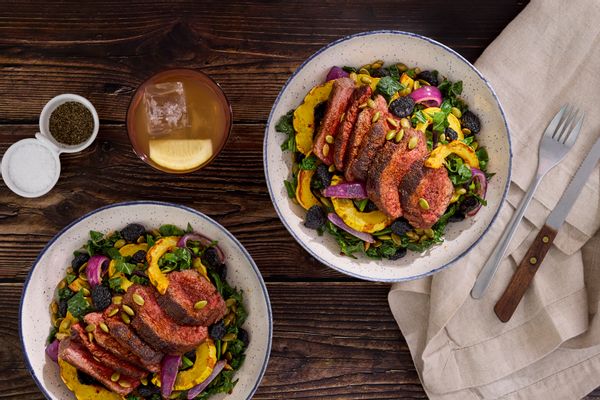Harissa-spiced pork and kale salad with squash and dried cherries