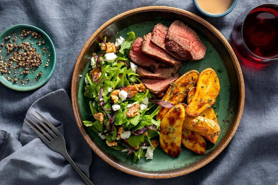 Black Angus steaks with herbed potatoes and arugula-walnut salad