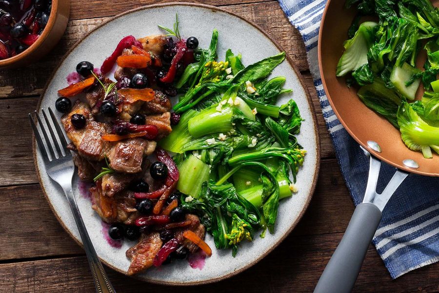 Seared pork with blueberry-apricot sauce and sautéed greens