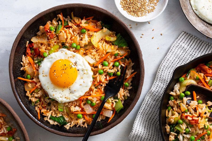 Kimchi fried rice with peas, bok choy, and fried eggs