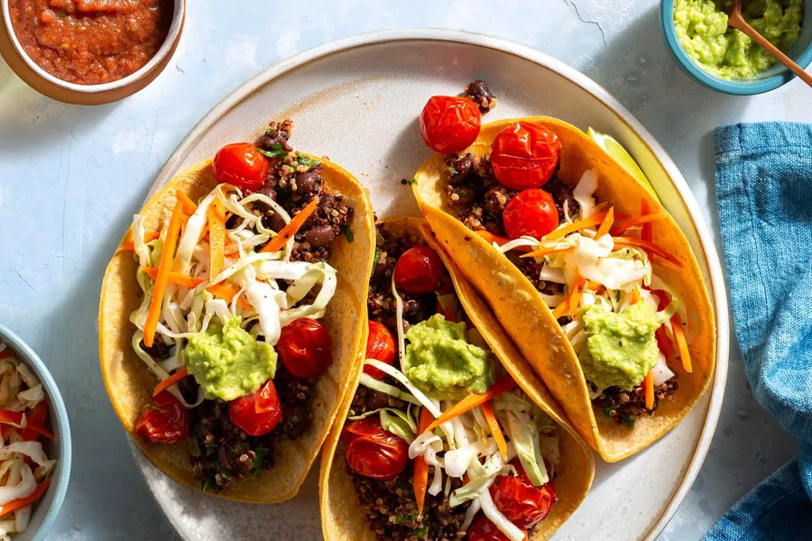 Rainbow quinoa–black bean tacos with guacamole and cabbage slaw