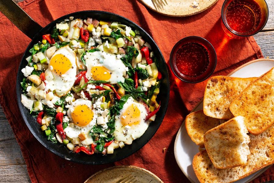 Baked eggs in spinach and leeks with chili-spiced ciabatta