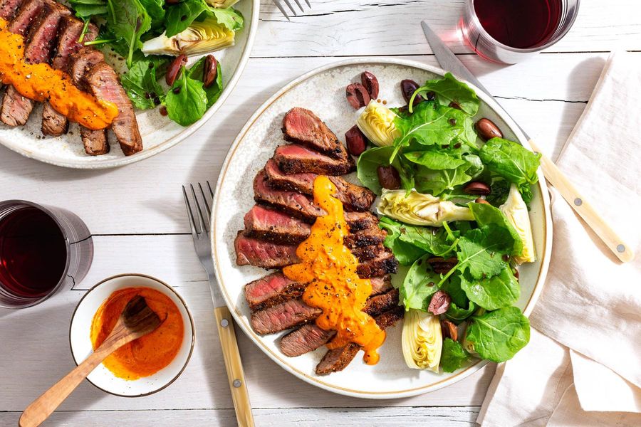 Black Angus rib-eyes with romesco and artichoke-olive salad