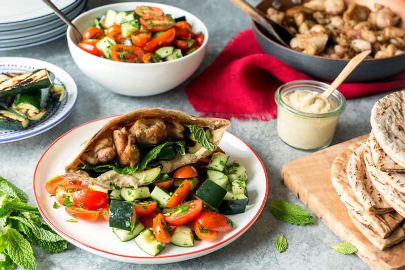 Mediterranean chicken pitas with hummus and tomato-cucumber salad ...