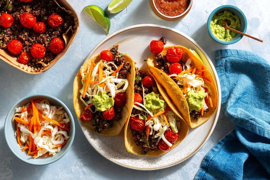 Rainbow quinoa–black bean tacos with guacamole and cabbage slaw