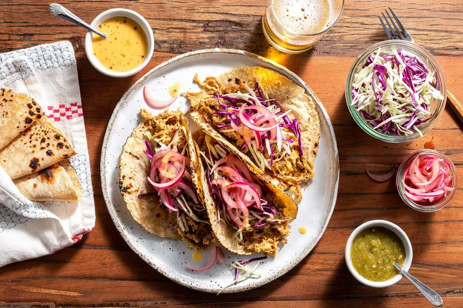 Pork carnitas tacos with pickled onions and salsa verde