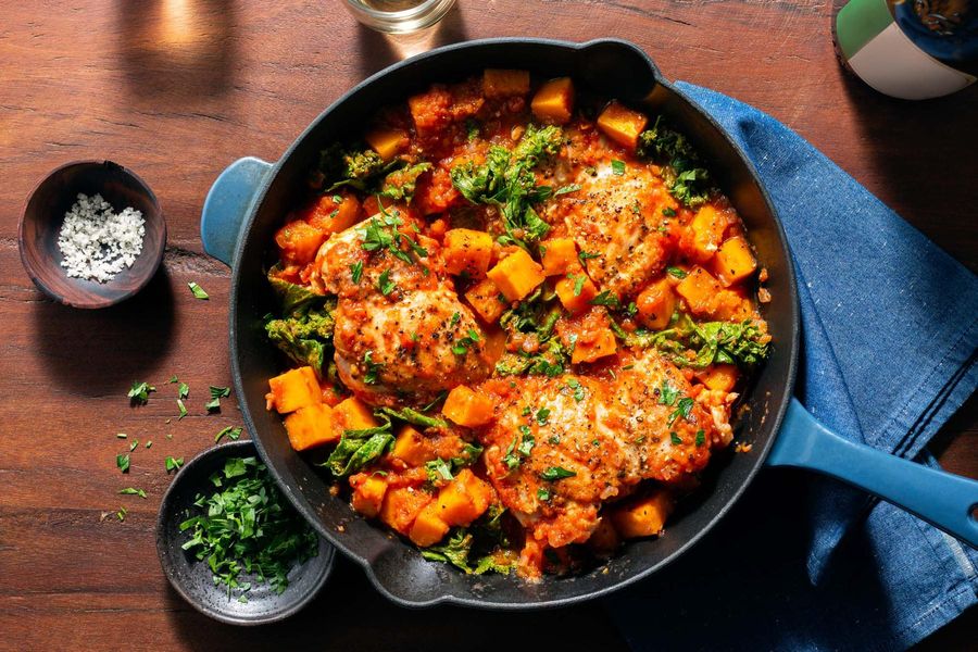 Tomato-braised chicken with butternut squash and leafy greens