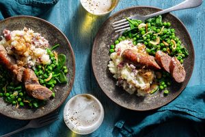 Bangers and mash, shallot gravy, and peas and spinach
