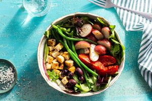 Niçoise salad with seared tofu and charred tomato wedges