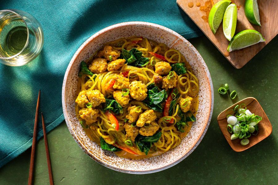 Chicken curry noodle bowls with broccoli leaves and bell pepper