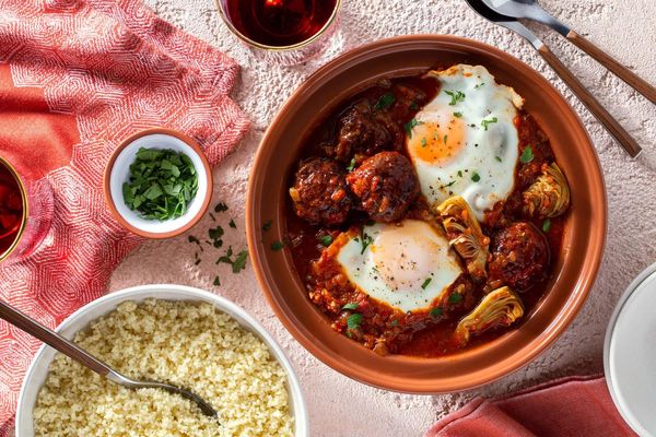 Moroccan lamb tagine with artichokes, tomato-poached eggs, and couscous
