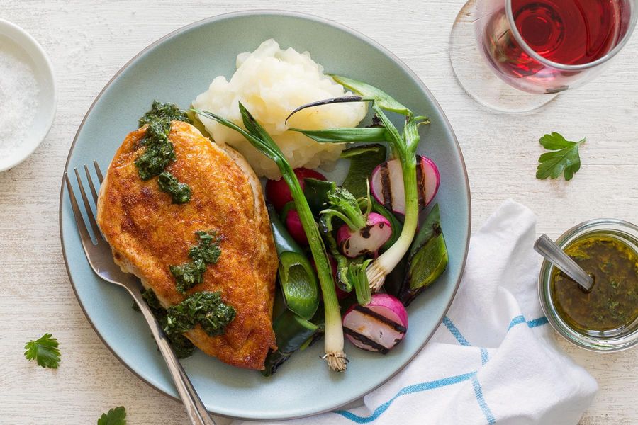 Chicken with yuca mash and grilled radishes, scallions, and poblano