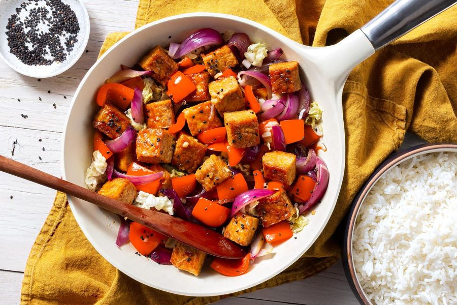 Teriyaki tempeh and bell pepper stir-fry over steamed rice