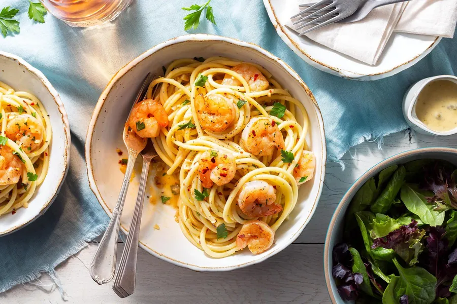 Shrimp scampi with bucatini and baby greens