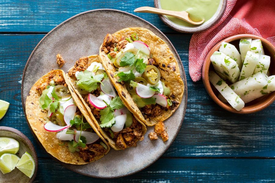 Tofu mole tacos with jicama, radish, and avocado crema