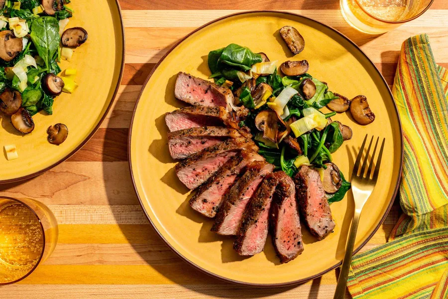 Black Angus steaks with garlic-herb ghee, mushrooms, and spinach