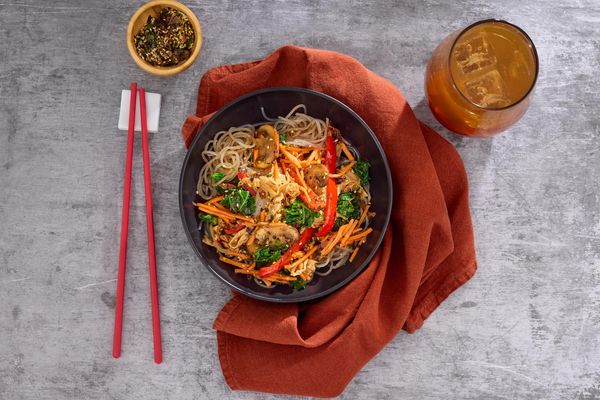 Yuba japchae bowl with glass noodles, mushrooms, and pickled carrots