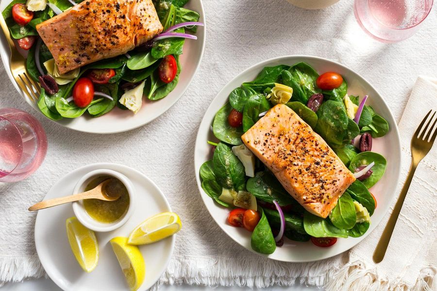 Lemon-pepper salmon over Greek salad with artichokes and olives