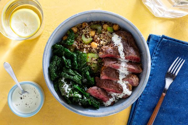 Salmon and quinoa bowls with wilted greens and citrus dressing