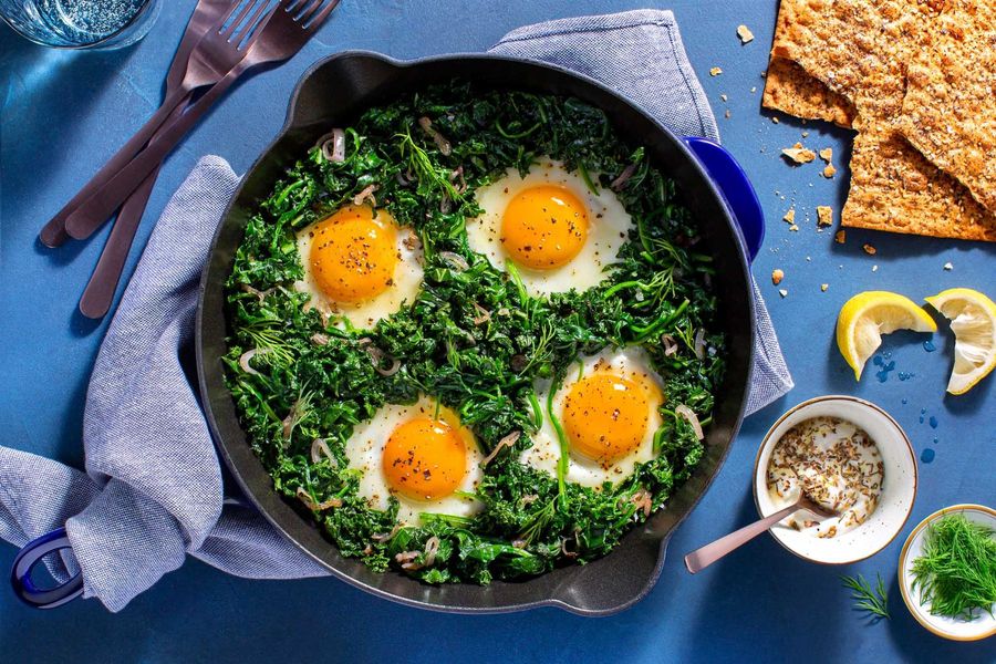 Shakshuka with greens, seeded lavash, and lemony yogurt