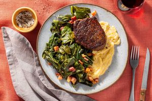 Black Angus steaks with collard greens and pancetta over cheesy polenta