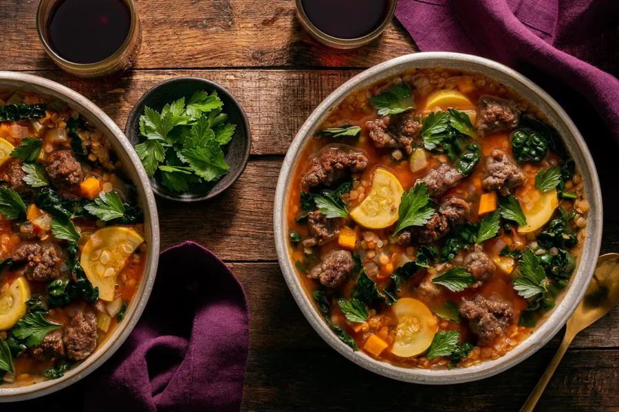 Mediterranean lentil stew with your choice of protein and wilted kale