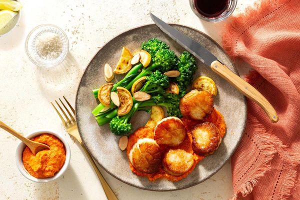 Steaks and romesco with baby broccoli, summer squash, and almonds