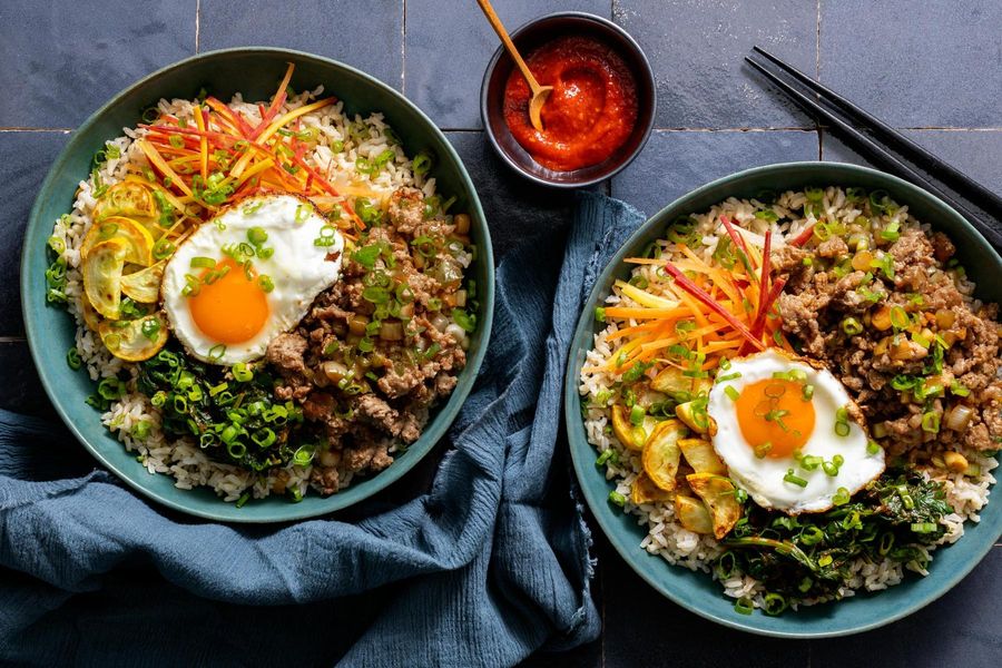 Korean bibimbap with spinach, squash, and fried eggs