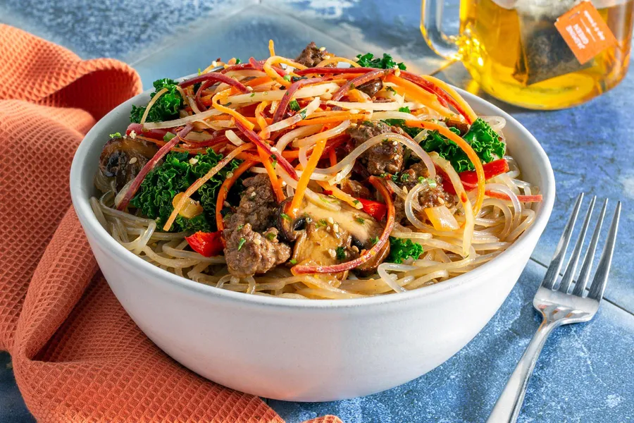 Beef japchae bowl with glass noodles, kale, and mushrooms