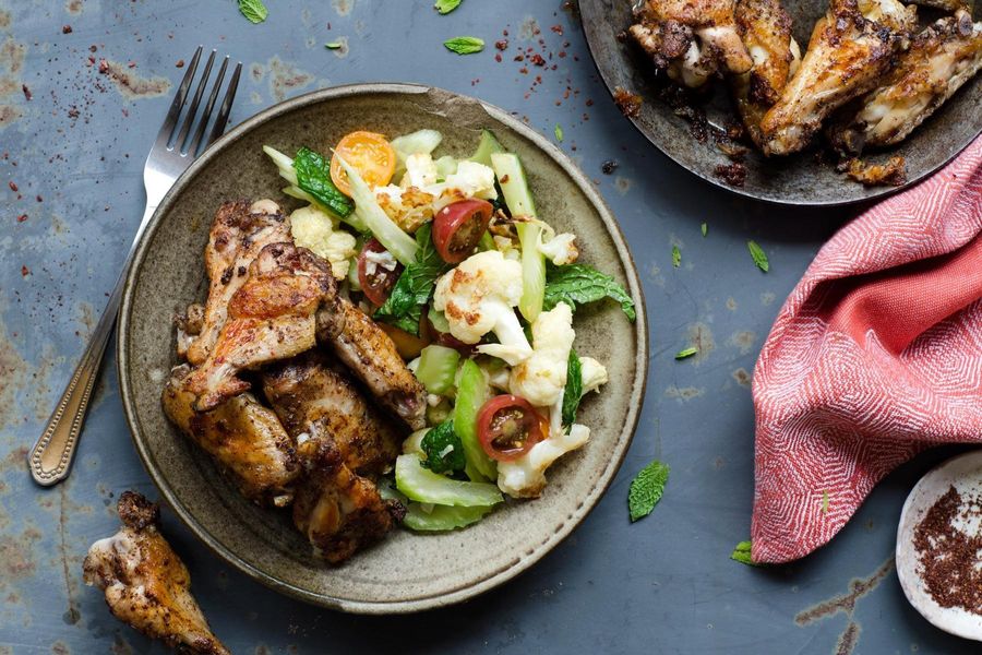 Moroccan chicken wings with cauliflower and tomato salad