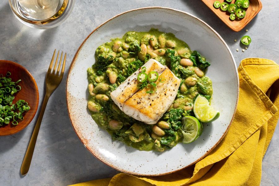 Barramundi over creamy white beans with spinach and parsley-pecan pesto