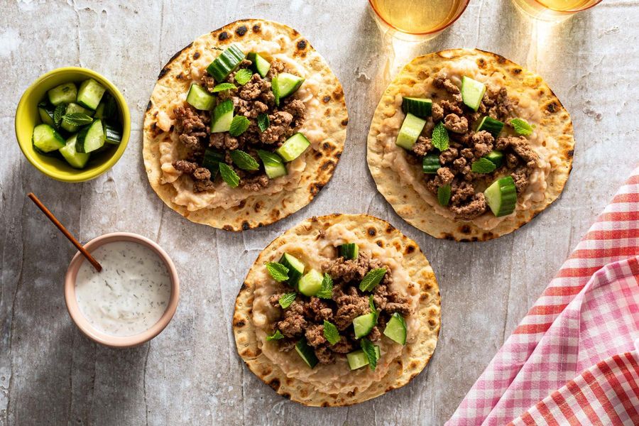 Lamb flatbread “tacos” with white bean mash and cucumber-mint relish