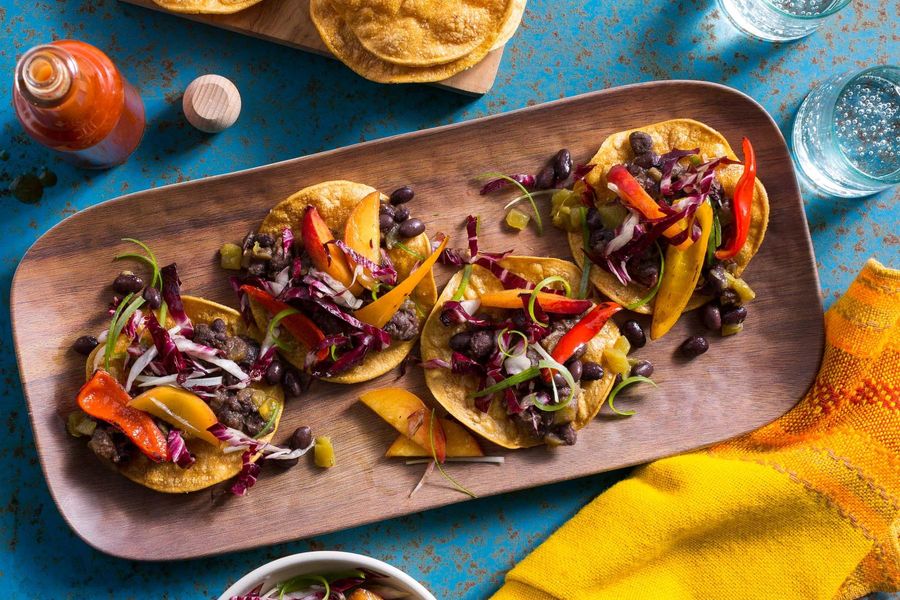 Spicy Jamaican black bean tostadas with peppers and nectarine slaw