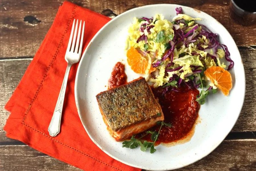 Seared salmon in chraimeh sauce with winter slaw