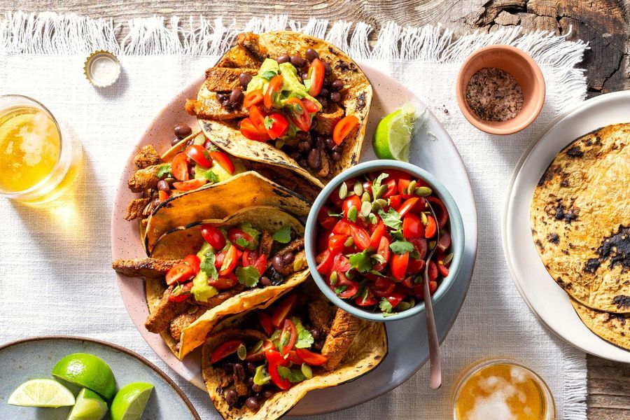 Spicy mojo-marinated steak fajitas with guacamole and salsa