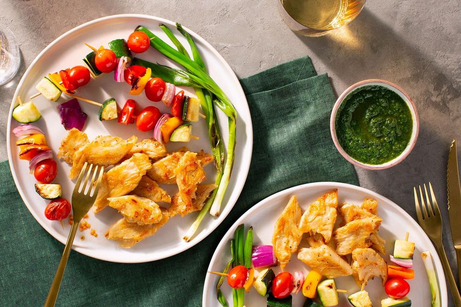 Vegetable skewers and your choice of protein with spicy green harissa