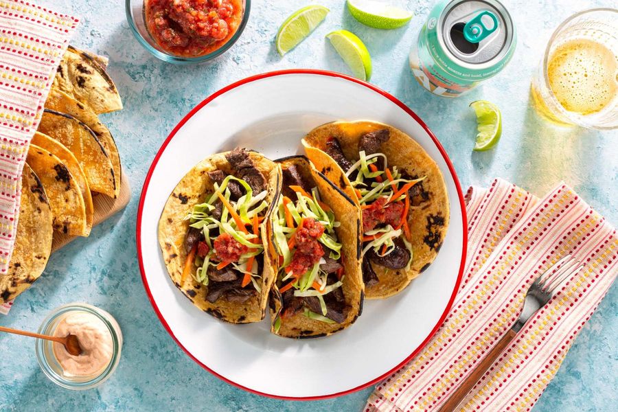 Salmon tacos with cabbage slaw, salsa roja, and chipotle yogurt