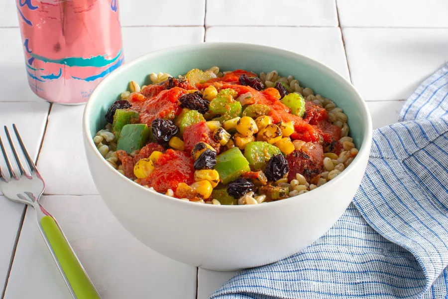 Creole barley veggie bowl with corn and spicy red pepper sauce