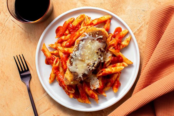 Chicken Parmesan with basil marinara over penne