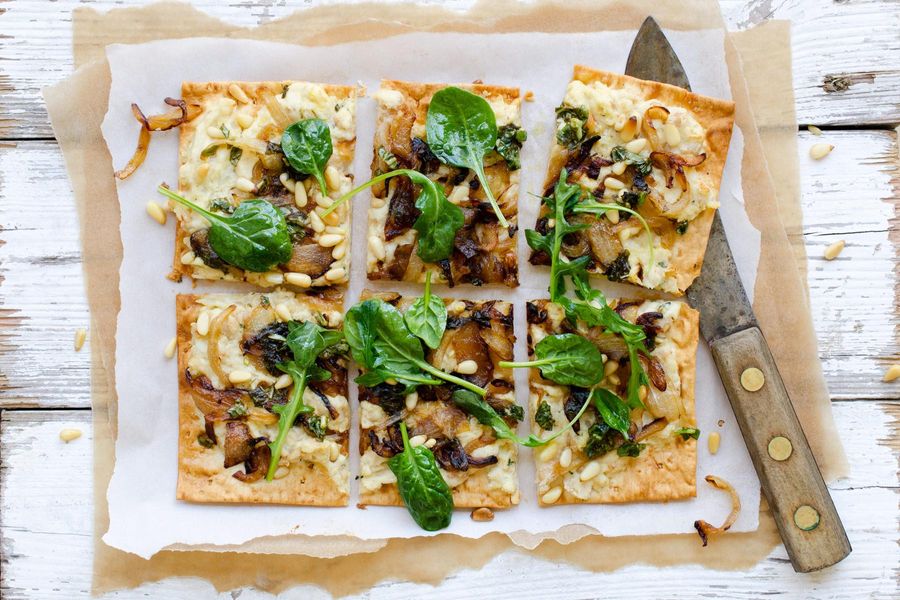 White bean and ricotta flatbreads with pine nuts and caramelized onions