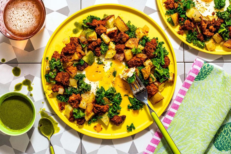 Kale and potato hash with runny eggs and spicy green harissa
