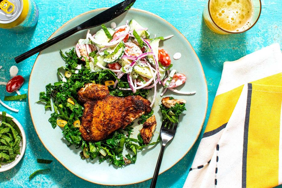 Baharat chicken over wilted kale with tzatziki salad