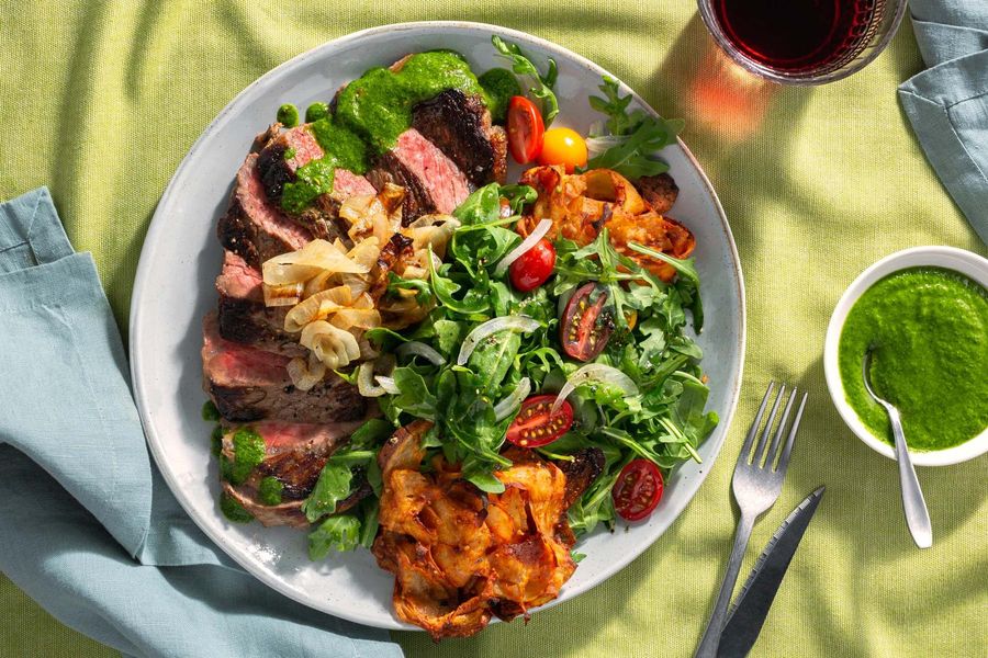 Black Angus steaks with chimichurri, crispy potato cakes, and arugula