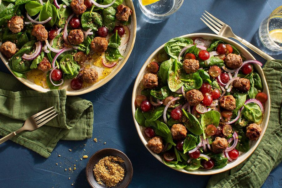 Kefta-spiced meatballs with spinach-grape salad and pumpkin seed dukkah