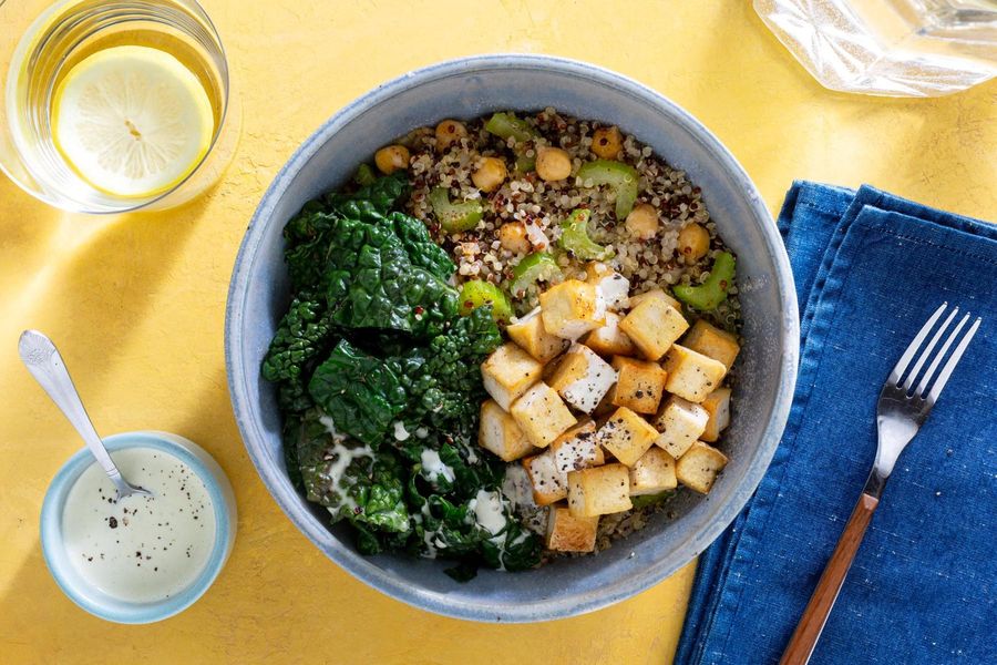 Quinoa bowls with wilted greens and citrus dressing