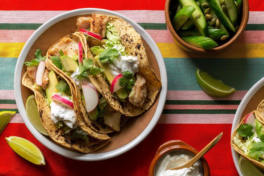 Fish tacos with avocado, Baja cucumber salad, and mint-yogurt sauce