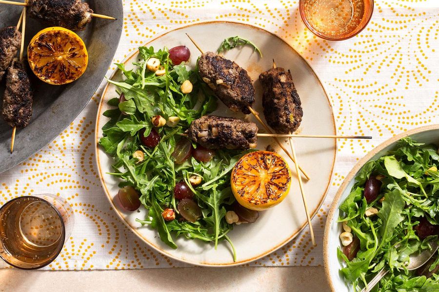 Greek souzoukaklia skewers with arugula-grape salad